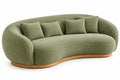 Canapé vert courbé à dossier enveloppant et socle beige